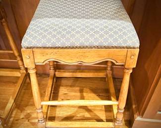 Two wood stools with upholstered seats