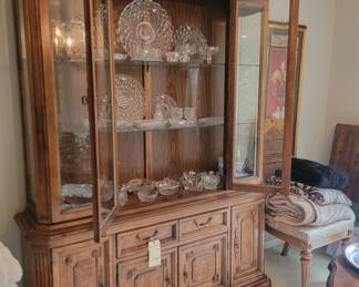 Matching china cabinet by Thomasville with glass shelving and plenty of storage.