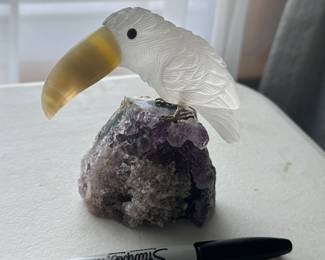 Carved stone figures on amethyst....