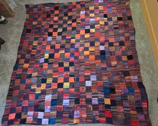 Purchased at the Sunday Market in Chiangmai, Thailand. This large, colorful handmade patchwork quilt is a vibrant blend of tradition and artistry. Made up of 3.5" squares, it's about 87" x 81", has a black fabric backing, and will make a one-of-a-kind addition to any home.