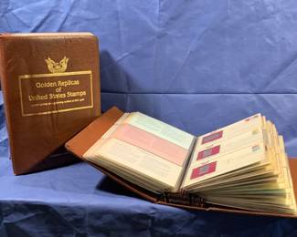Pair of albums: 22kt plated reproductions of U.S. postage stamps.