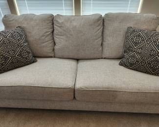 Grey Fabric Sofa with Decorator Pillows. 
