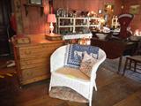 Antique dresser with hanky drawers, wicker settee (possibly Heywood-Wakefield) with caned seat (original cushion underneath)