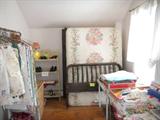 table linens (on rack), book shelf, wicker hamper, and Jenny Lind bed with mattress
