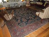 Living room oriental rug. Photo not a true depiction of actual color. It is a prodominantly dark (not navy) blue with red border. Both rugs are nice deep colors, not faded.