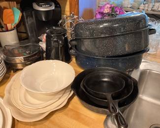 Kitchen -,Keurig in back, waffle maker (round) platters & bowls, iron skillets & baking pans