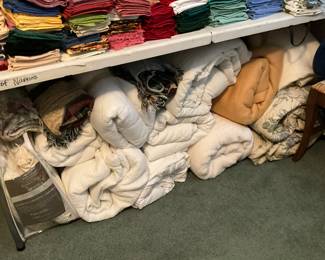 3rd bedroom - This area underneath the table contains set of linens for bed, bedspreads, comforters, bed covers & more!