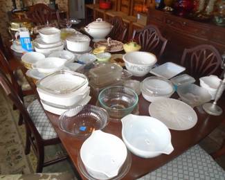 Tables full of cookware including Pyrex and Corning