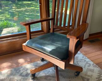 Mission style swiveling desk chair with green leather seat & castors