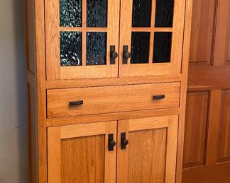 Mission style cabinet with black ripple glass