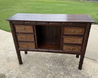 Tommy Bahama wood console table with rattan detailing. Solidly built — a must-see piece.