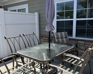 Glass top table with 6 chairs, umbrella, umbrella stand and cushions. 250.00.