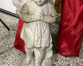 Many concrete statues… girls, boys, angels, etc