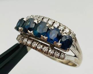 18K white gold size 7.75 ring with a center row of (5) bright sapphires flanked by a row of (10) diamonds above and below. 4.73 gtw.