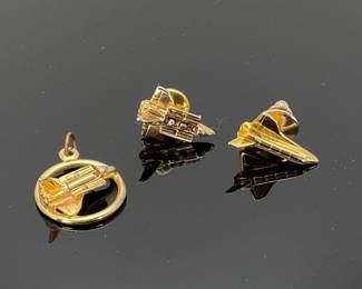 Vintage gold tone space shuttle 1" pendant with space shuttle. And (2) gold tone space shuttle lapel pins.