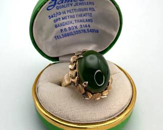 12K gold size 7.75 ring with an 18.7mm x 14.5mm oval cut green chrysoprase cabochon at the center. 8.65 gtw.