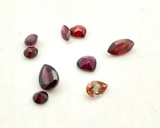 Nine (9) assorted red toned tourmaline stones. Mixed shapes and sizes. 4.55 ctw.