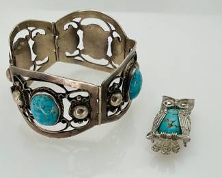 Sterling silver (4) panel 7" length by 1 1/2" width bracelet. Each panel features an 18.5mm x 12.5mm turquoise cabochon. Stamped "Sterling 925 D.R.G. Hecho in Mexico". Silver owl pin with faux turquoise center stone. Stamped "Beau Sterling".