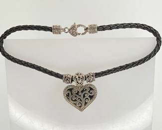 15" braided leather necklace with silver tone heart pendant. Similar in style to Brighton.