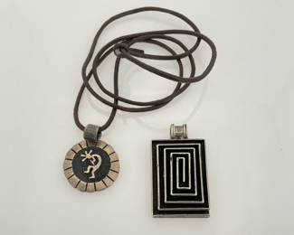 Sterling silver and black geometric rectangle pendant, H 2" x W 1". Stamped "925". Kokopelli 1" round sterling silver pendant on a 24" leather cord. Stamped "Sterling". 33.96 gtw.