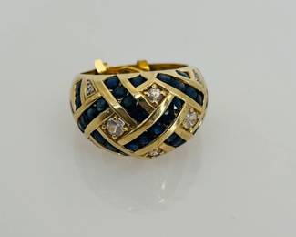 10K Gold Blue and White Topaz dome style ring with a sizer, sized down to size 5. Missing (1) stone. Stamped "10K". 6.0 gtw.