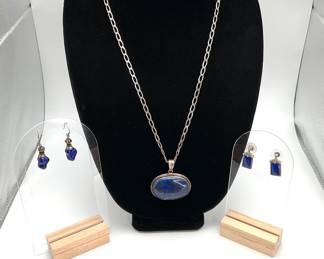 Lapis Lazuli 1 1/2" oval pendant on a 23" silver chain (stamped 925). Two sets of coordinating dangle earrings.