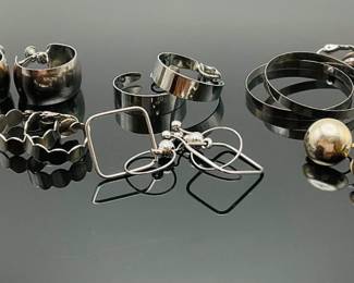 Six (6) pairs of silver tone clip on earrings including (4) pairs of hoops.