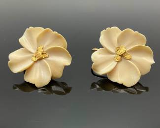 Cream colored flower clip earrings, possibly bone, with a gold center.