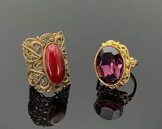 Two (2) statement rings, size 8 with purple stone and adjustable cuff with filigree design and orange stone, possibly carnelian.