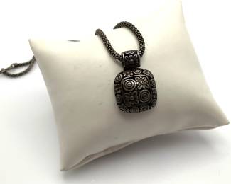 1" square pendant with floral design on an 18" popcorn chain. Both marked 925. 16.77 gtw.