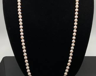 Mikimoto cultured pearl necklace. 32" length. Individually knotted, light pink color.