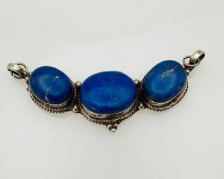 Silver pendant, that attaches on both sides, featuring (3) large lapis lazuli stones. Length 3 1/2". Stamped "925".