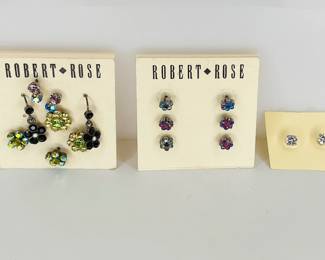 Eleven pairs of sparkling rhinestone earrings. Most are flower designs.