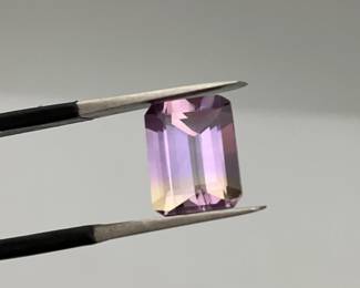 Emerald cut purple and green Ametrine gemstone. 9mm x 7mm. 2.25 ctw.