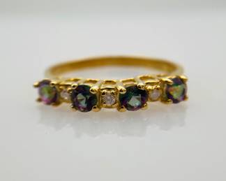 Four (4) prong set mystic topaz stones, 0.4 ctw, and (3) prong set diamonds, .02 ctw, are set in a 10K gold, size 6.5 ring. 1.54 gtw. Includes certificate provided by consigner.