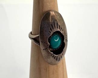 Unmarked ring, appears to be silver, with a turquoise center stone. Size 6 1/2. 4.91 gtw.