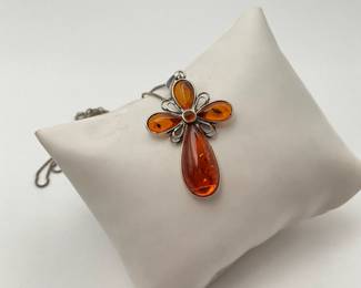 A 1 1/2" amber cross set in silver hangs from an 18" silver box chain. Chain and pendant stamped 925. 6.54 gtw.