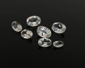 Seven (7) white topaz gemstones, mixed shapes and sizes. 4.75 ctw.