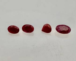 Four (4) ruby gemstones. Mixed shapes and sizes. 0.60 ctw.