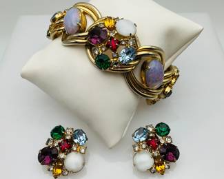 Unmarked bracelet with safety clasp featuring large stones a mixture of glass and tourmaline colored stones. Clip earrings also feature a mix of tourmaline and glass stones.