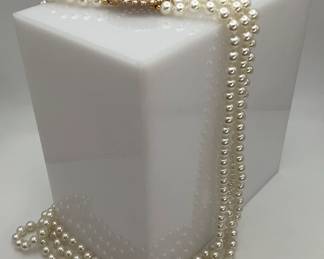 Three strand tiered pearl necklace with rhinestone accent piece. Cannot authenticate pearls.