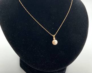 A delicate pearl pendant topped with a diamond hangs from a 16" 14K gold chain. The chain is stamped "IPS 14KP". 1.57 gtw.