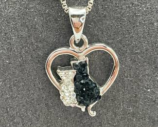 Sweet black and white cats sitting in a 1/2" heart pendant on a 16" silver box chain, stamped 925.