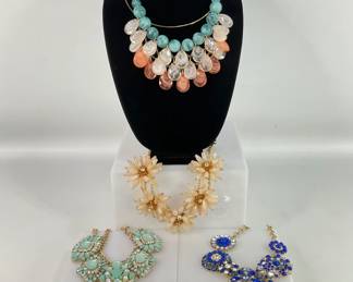 Four (4) large beaded and rhinestone statement necklaces. Vintage 60s large flower bead and rhinestone necklace. Beaded Statement Necklace, gold tone with round aqua beads and peach and clear teardrop beads. Bright blue rhinestone statement fashion necklace, possibly CARA New York, but no markings found. Light turquoise beads and clear rhinestone statement necklace.
