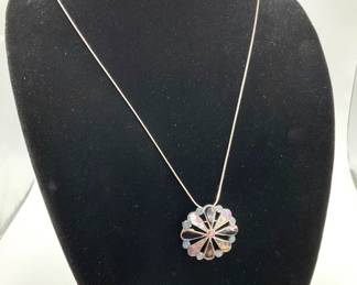 Vintage sterling Taxco 1 1/2" brooch pendant. Inlaid with abalone, onyx and turquoise and hanging from a 23" sterling silver chain (stamped 925).