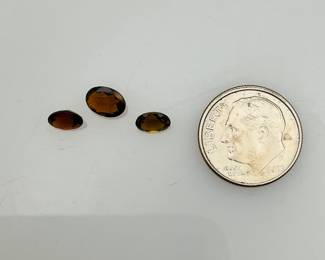 Three (3) brown topaz oval cut gemstones. 1.55 ctw.