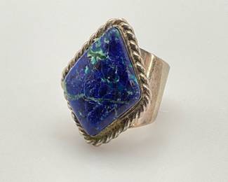 A large 1 1/4" diamond shaped azurite stone is set in sterling silver on this size 5 ring. 12.50 gtw.