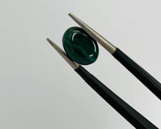 Oval cut 6mm x 8mm emerald cabochon gemstone. 1.2 ctw.