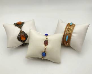 Vintage gemstone mini scarab bracelet featuring (5) carved stones set in a 7" gold tone bracelet. Amber art deco style 6 1/2" bracelet. Vintage style mesh 7" bracelet with blue stone accents and gold tone filigree details.