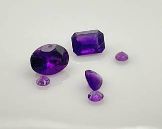 Six (6) amethyst gemstones. Mixed shapes and sizes. 3.5 ctw.